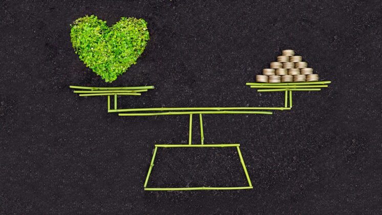 A sketched scale shows the value of balancing heart and money with a new economic model