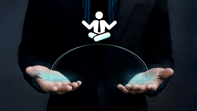 Japanese salaryman holds palm open to tech-rendered icon of a businessman in a yoga posture