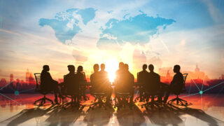 4 Characteristics + Gratitude: The Secret Recipe for Great Global Leaders A table of global leaders with a bright sky in the background