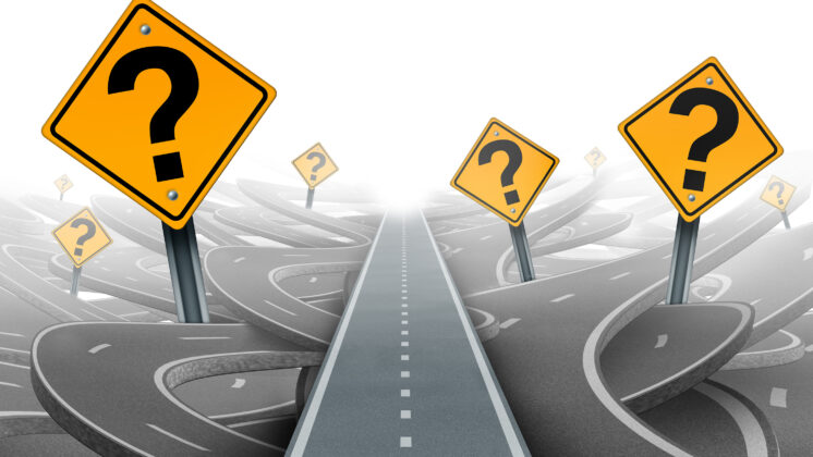 A single straight road cuts through twisted streets with question mark signs, a path forged by VUCA leadership