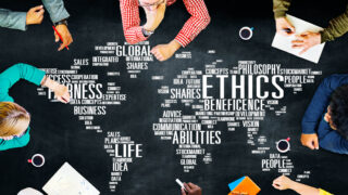 8 Scales to Chart a Culture Map for Better Management People sit around a culture map of the world made of different cultural buzzwords