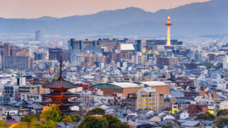 Japanese Values & Longevity: The Oldest Companies in the World A red pagoda stands across a city from a modern tower, showing the endurance of Japanese values in modern times