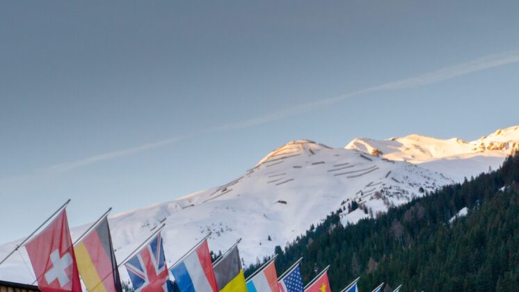 the congress center in Davos with flags of nations at sunrise during the WEF World Economic Forum