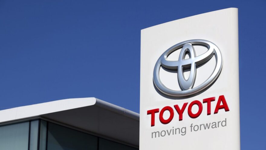The Toyota logo dominates the sign at a Toyota dealership