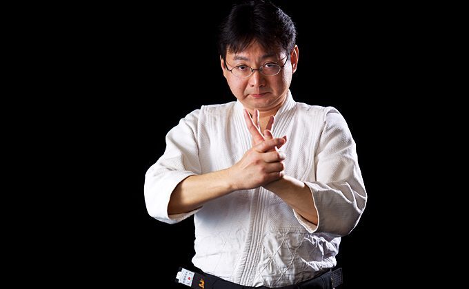 Tomoya Nakamura in aikido gear twists his left hand