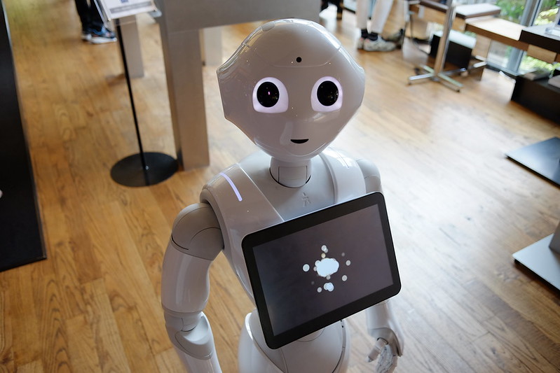 Pepper, a short white robot, helps out at a cafe in Tokyo.