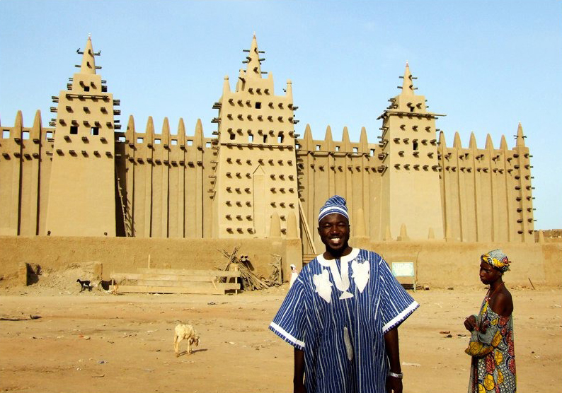 Dante Mahamoud poses in front of the Great Mosque of Djenné in Mali, his home country where he hopes to make social impact
