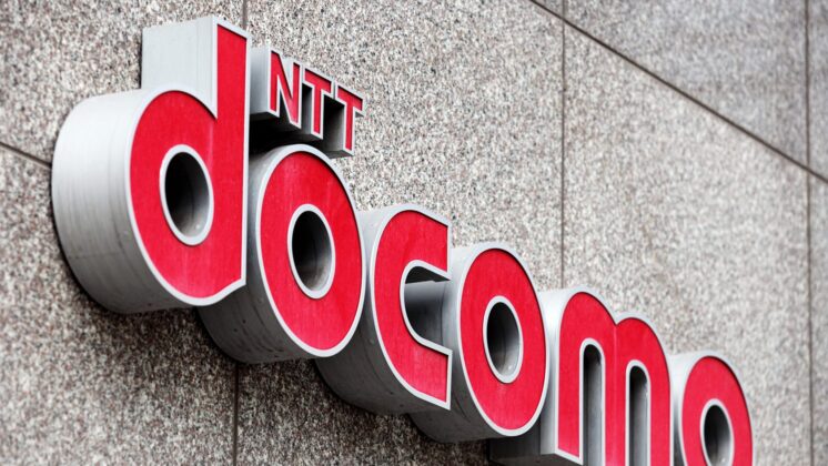 An outdoor wall shows the NTT docomo logo