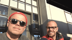 Friends and Pickit cofounders Henrik Bergqvist and Mathias Bjorkholm sit together outside on a sunny day
