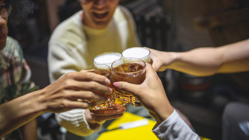 Friends having a beer in Japan's high-context culture observe rules about drink orders