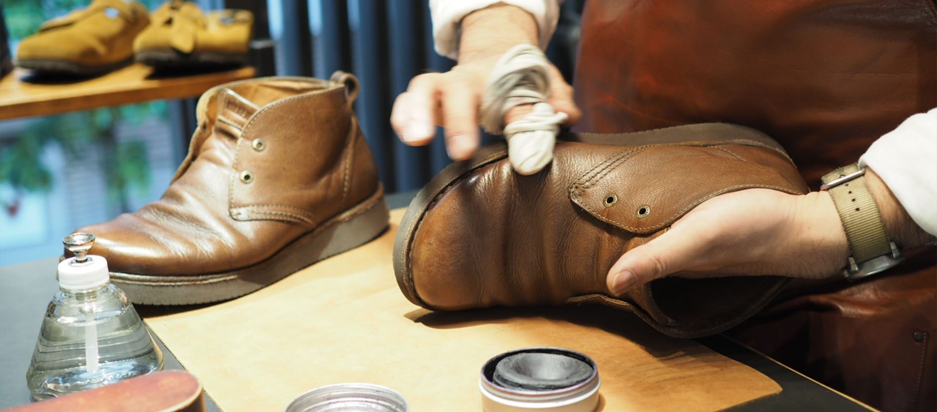 BENEXY staff performing shoe care on a pair of shoes, prolonging shoe life for health and fashion