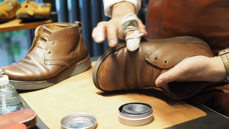 BENEXY staff performing shoe care on a pair of shoes, prolonging shoe life for health and fashion