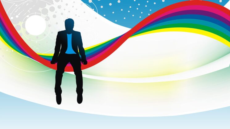 A businessman sits in silhouette on a rainbow against a complex sky, contemplating coming out at work