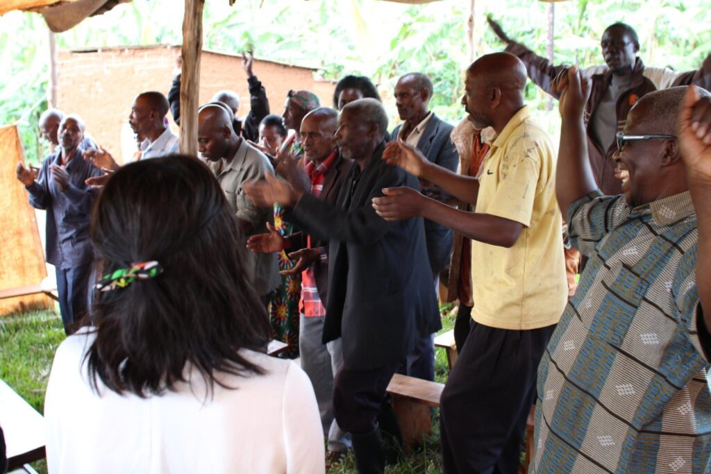 Members of a reconciliation program greet a peacebuilding tour with song and dance.