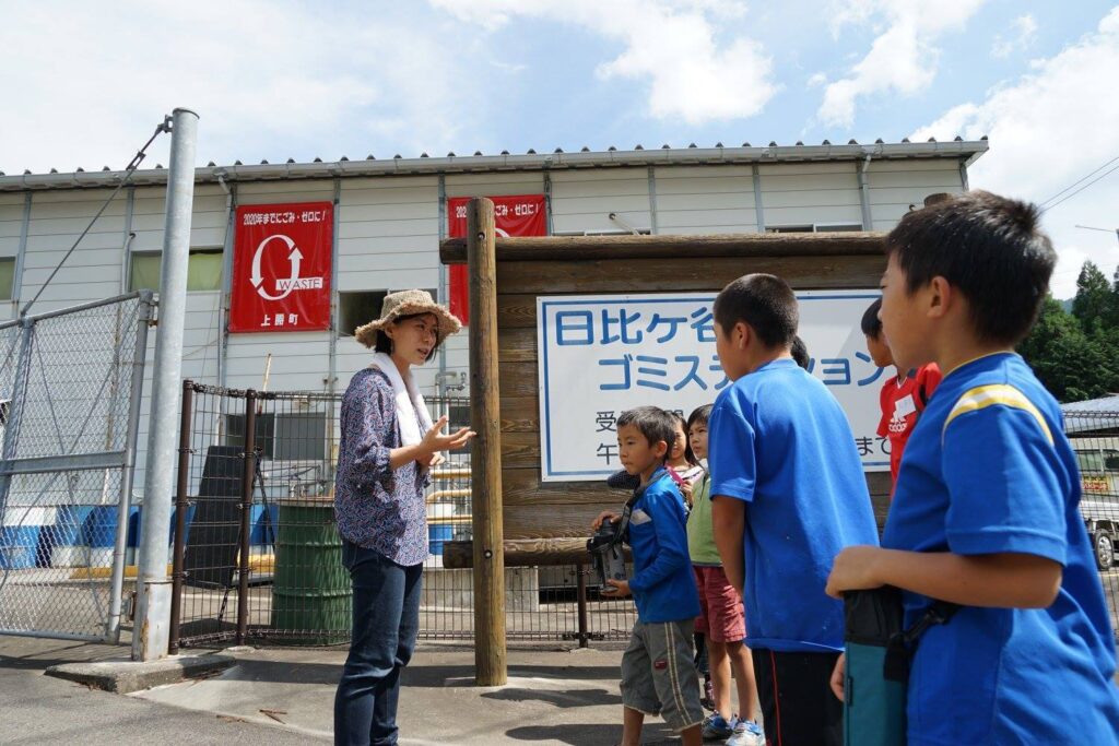 Akira Sakano tours a group of children around a zero-waste recycling facility in Kamikatsu-cho