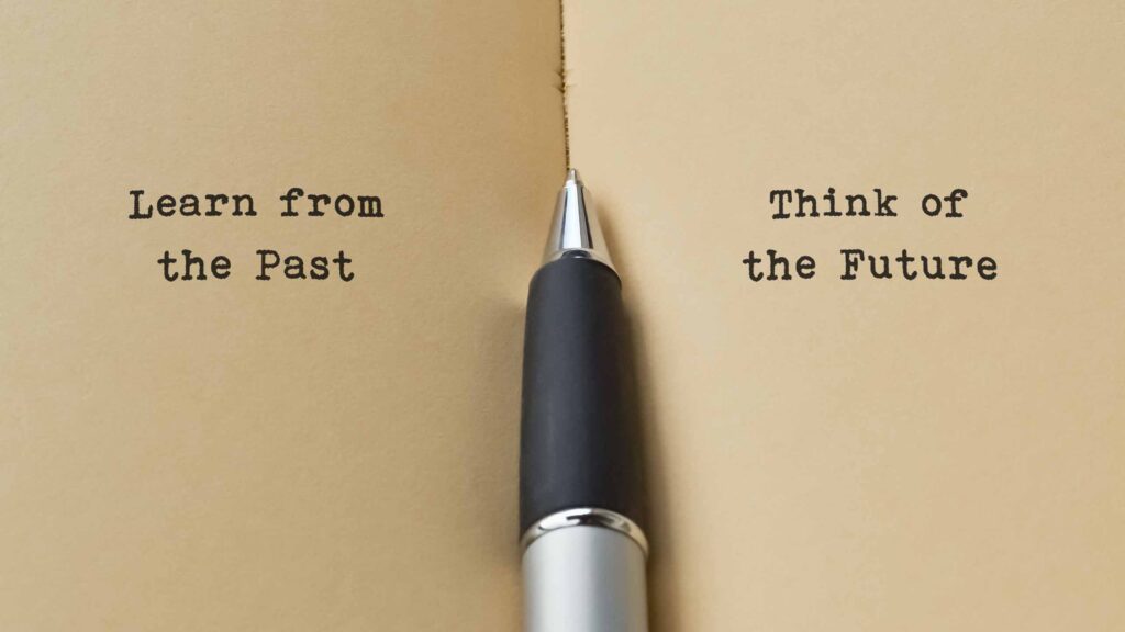Pen sitting between two pages that read "Learn from the past" and "Think of the future," indicating why failure is good for success with the right mindset