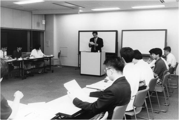 Black and white image of Yoshito Hori teaching in the rented classroom where GLOBIS was born