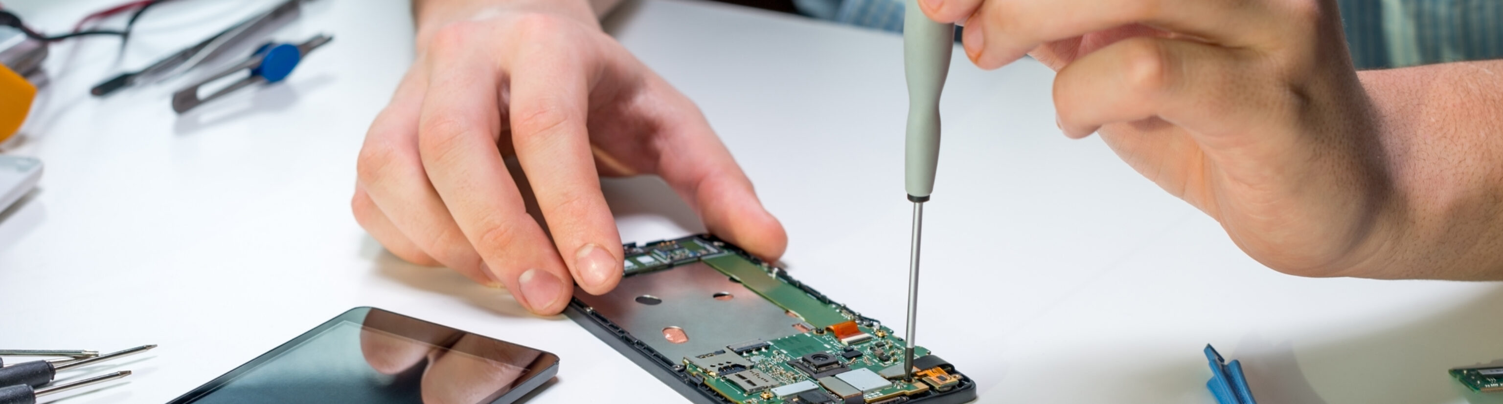 A person repairing a smartphone—an important element of sustainable technology