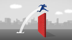 An illustration of an office worker jumping over a brick wall representing barriers to critical thinking.