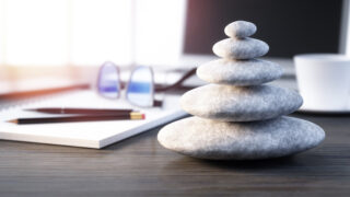 Japanese Values for Better Business in the Modern Age Stack of pebbles on a workplace desktop show how Japanese values impact business philosophy