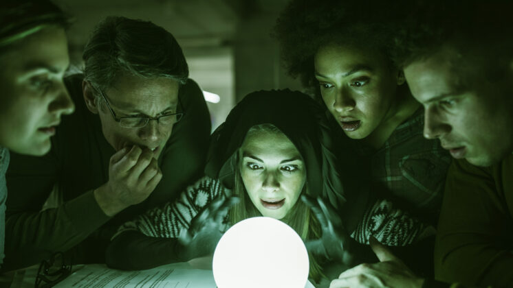 Coworkers huddle around a crystal ball letting off a green glow to find the source of their toxic work culture