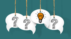 Question cards hang from strings with one showing a lightbulb to indicate it's one of the best critical thinking questions