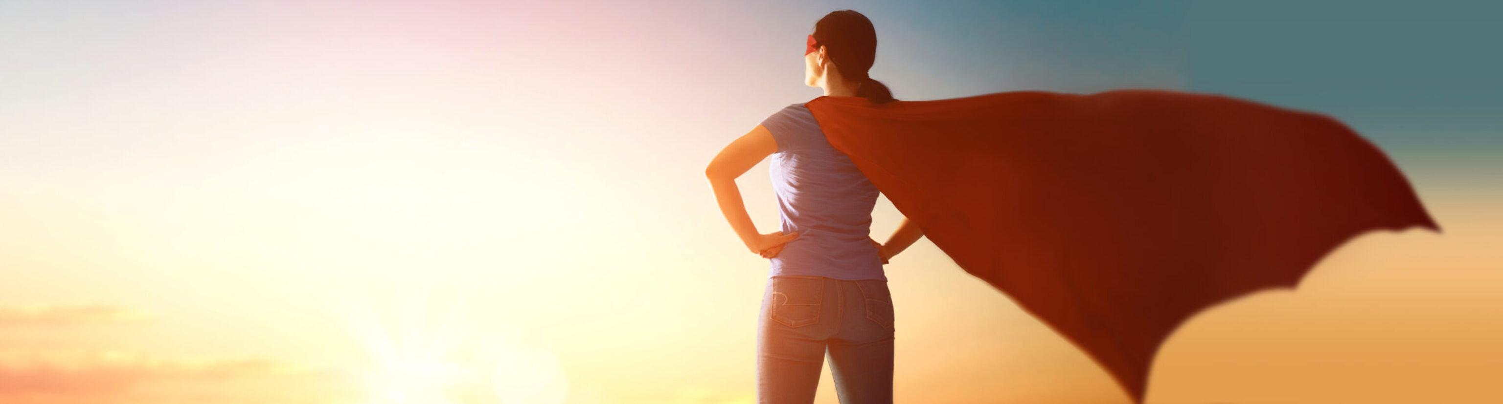 A female leader in business wearing a superhero cape.