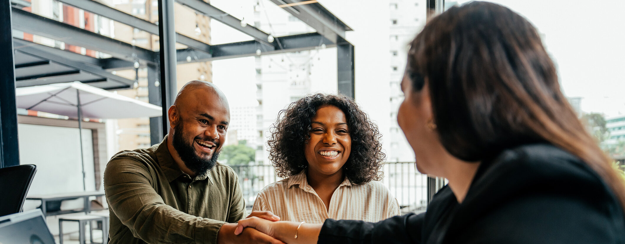 Couple closing real estate contract with real estate agent