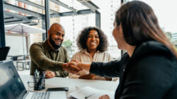 Couple closing real estate contract with real estate agent
